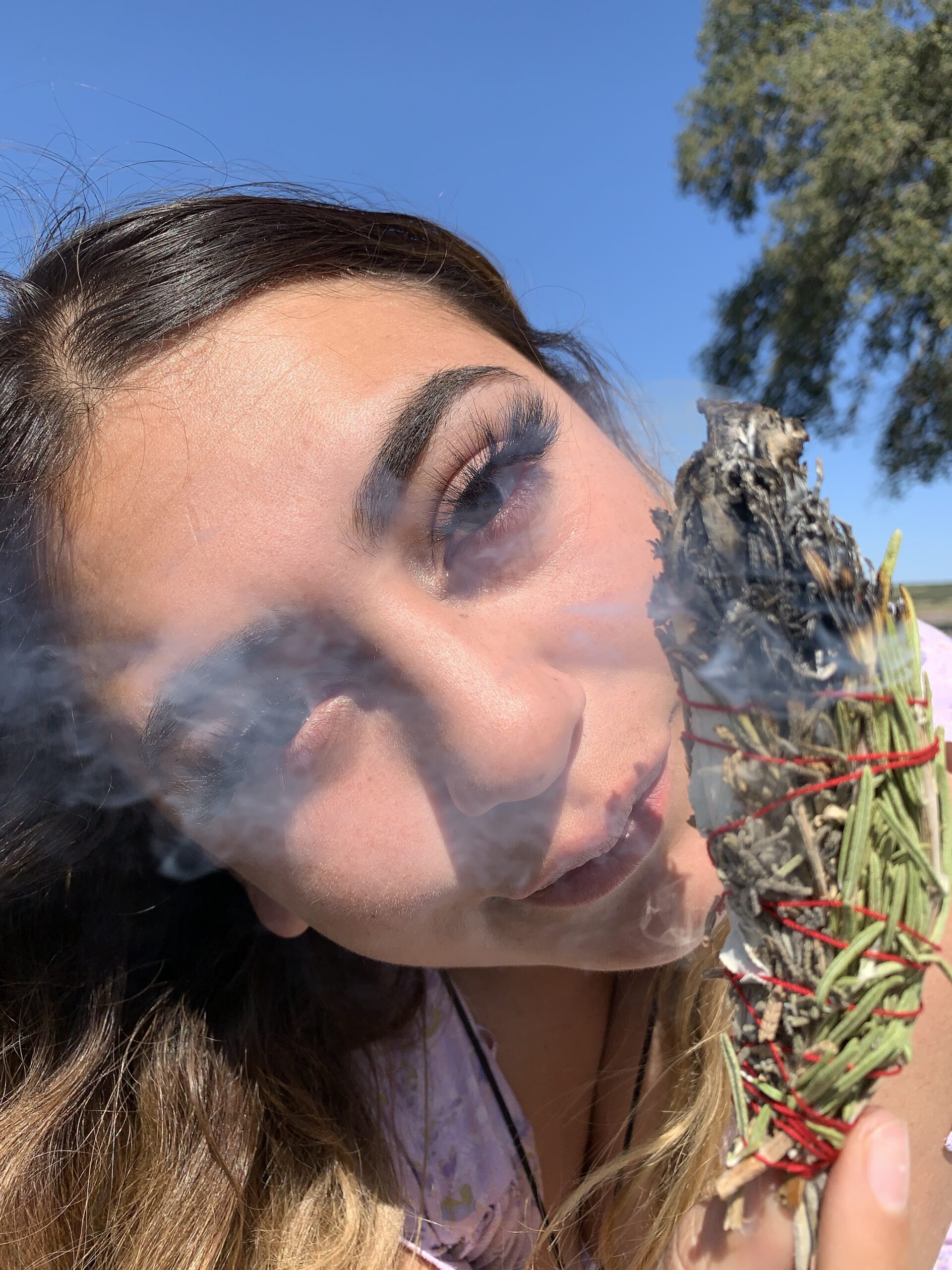 Photo of Amalia with burning Lagunitas Organics Aura wand
